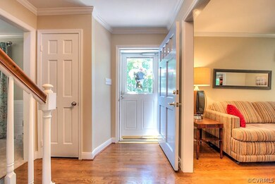 The hardwood Foyer opens to both the Living & Fami