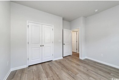 Unfurnished bedroom featuring a closet and light w
