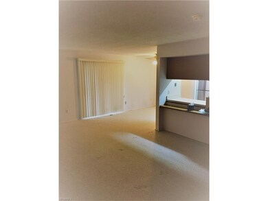 The dining room with ceiling fan opens to the kitc