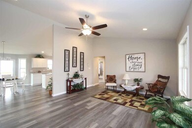 Living Room With Stylish Flooring, Vaulted Ceiling