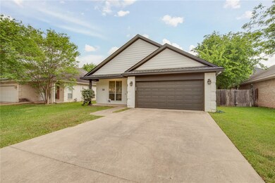Ranch-style home featuring a front yard, driveway,