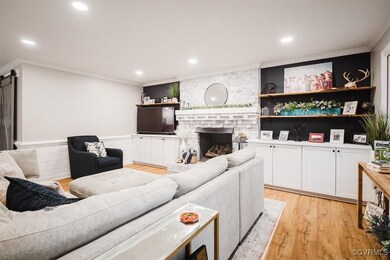Living room with a fireplace, light wood-type floo