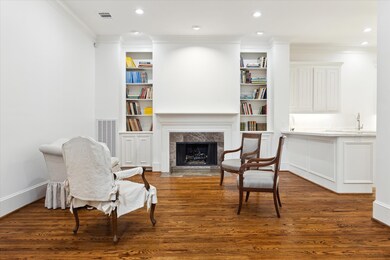Family Room open to the kitchen shows cozy firepla