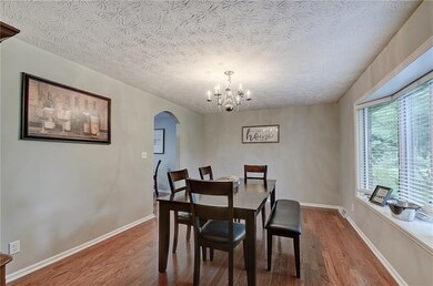 Hardwood floors, along with the bay window and arched doorway leading to the breakfast nook, add character to the spacious dining room.  This flexible space could also be another living area.