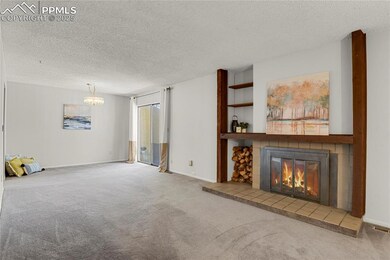 New paint in living room, carpet, a tiled fireplace, and a chandelier