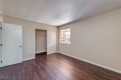 Unfurnished bedroom with dark wood-style flooring,