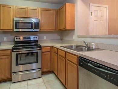 The kitchen features stainless appliances and a br