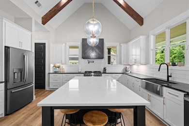 Chef-inspired kitchen with generous island, modern finishes, and open flow to living space.