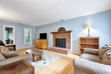 A stately brick fireplace and mantle anchors the family room.