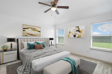 The cozy primary bedroom is tucked away at the back of the home with tranquil views of the green backyard!