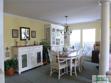 Dining room is spacious with crown molding and col