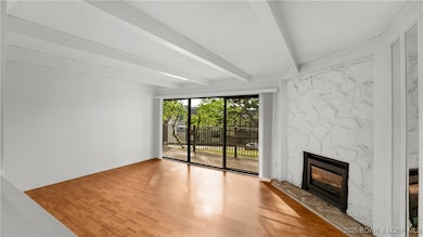 Cozy up around the charming fireplace in this spac