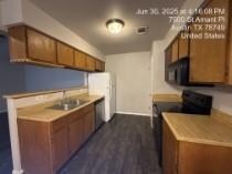 Kitchen featuring black appliances, brown cabinet