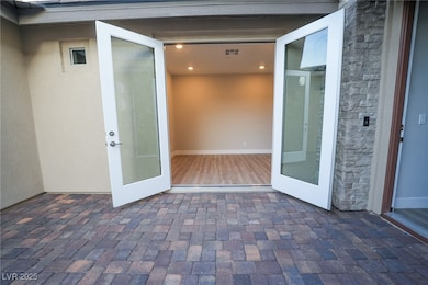 Entrance to property featuring stone siding and st