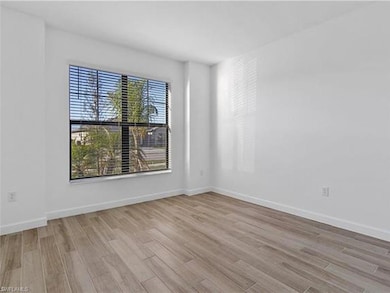 Empty room featuring wood finished floors and baseboards