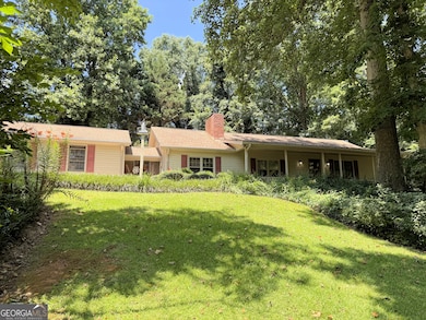 Nestled on a gentle rise, shaded by mature oaks and maples that have witnessed decades unfold, stands a home shaped by vision and devotion-a custom-built, one-owner residence completed in 1977 that has enduring design, and thoughtfully maintained.