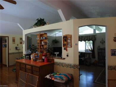 kitchen view to living room, entry and hall to bed