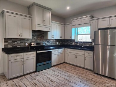 Kitchen featuring stainless steel appliances, light wood finished floors, tasteful backsplash, recessed lighting, and gray cabinets
