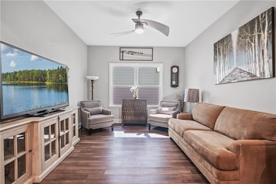Living area with dark wood-type flooring and a cei