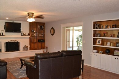 Living room with built-in bookshelves around firep