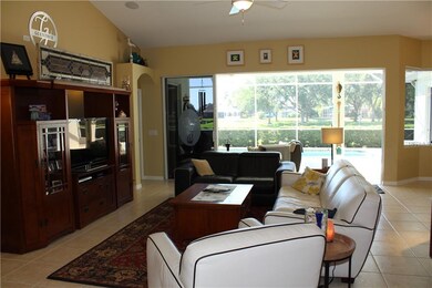 Open floor plan living room with views of the pool