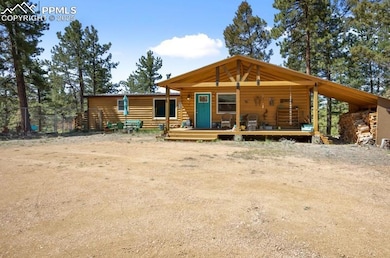 Log-style house featuring faux log siding and a deck