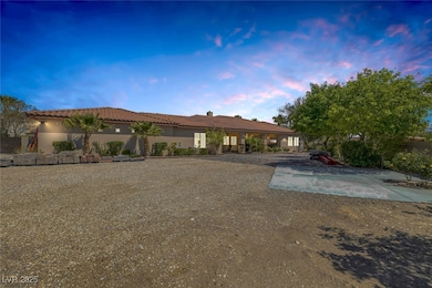 Rear view of property featuring stucco siding, a tiled roof, and a chimney