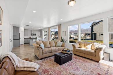 Living room with recessed lighting, light wood-type flooring, and a mountain view