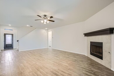 Unfurnished living room featuring ceiling fan, lig