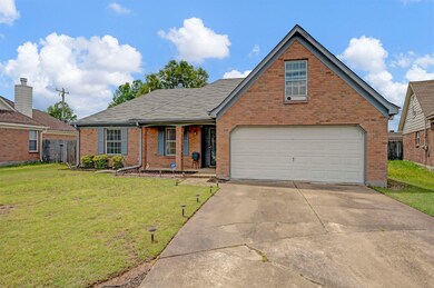 Traditional-style home with brick siding, concrete