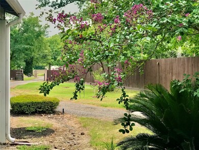 From the front door you have this view of the front remote controlled access gate. There is a long driveway with room for parking in front, along side & behind the home.