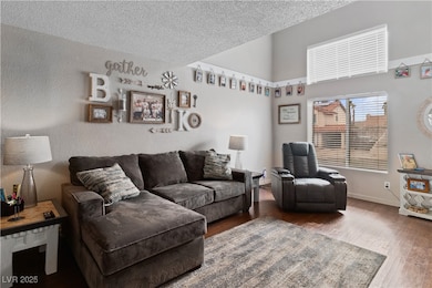 Living area featuring wood finished floors, a text