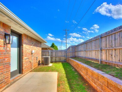 Fenced backyard with a patio area