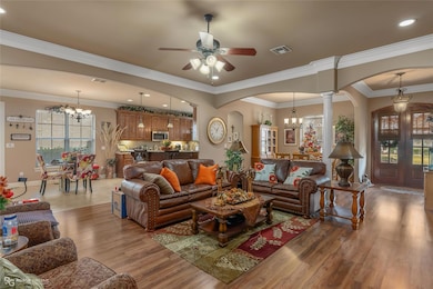 Living room featuring decorative columns, crown mo