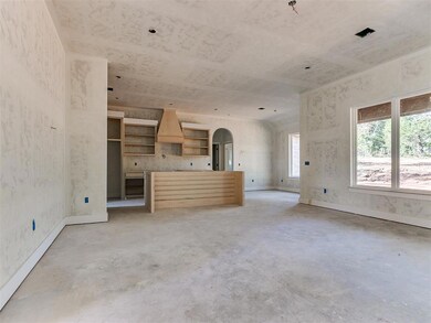 Unfurnished living room featuring concrete floors