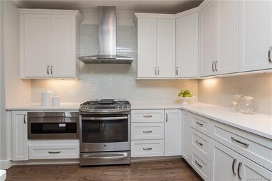 Gourmet kitchen features stainless appliances, qua