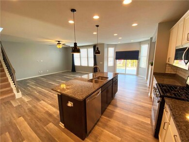 Open concept layout - kitchen open to great room with recessed lighting. 