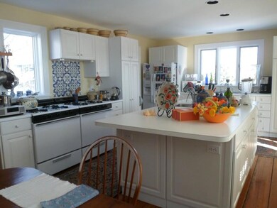 Spacious white kitchen with island