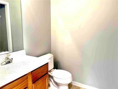 Half bathroom with vanity and vinyl patterned floors on main floor