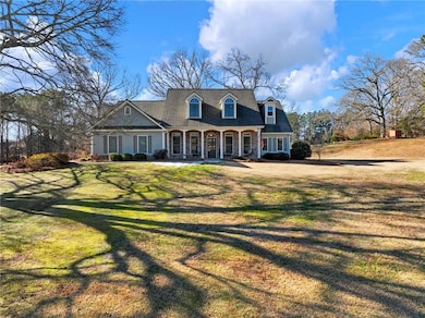 Cape cod house with a porch and a front lawn