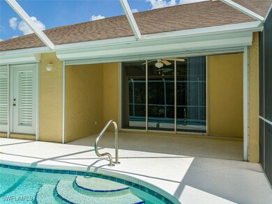 View of pool with glass enclosure and a patio area