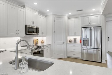 Kitchen featuring stainless steel appliances, back
