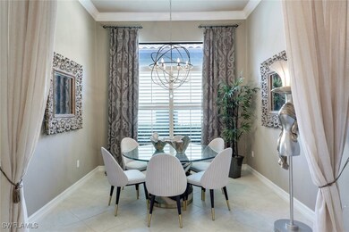 Dining space featuring a chandelier, baseboards, a