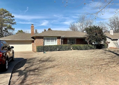 Single story home with brick siding, concrete driv
