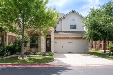 Traditional-style house featuring driveway, stone