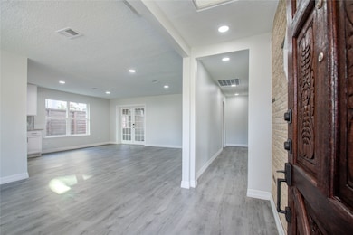 Front entrance with beautifully stained wood door.