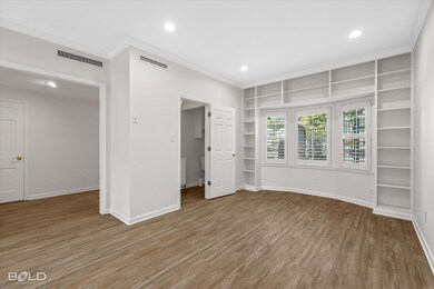 Unfurnished bedroom featuring crown molding and ha