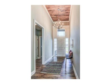 note the wooden ceiling treatment in the entry. 2 