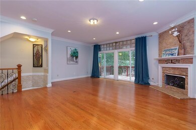 Living room with crown molding, light wood finishe