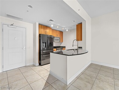 Kitchen with stainless steel appliances, dark coun